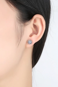Vue rapprochée d'une boucle d'oreille en zircone portée sur l'oreille en argent poli