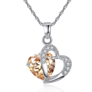 Double heart pendant necklace with champagne crystal and silver chain on white background