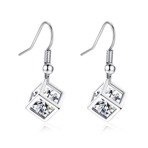 Detailed macro view of silver geometric hollow cube earrings with sparkling zircon stones