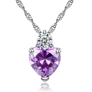 Macro detail of heart-shaped purple zircon pendant on silver twisted rope chain