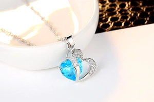 Detailed close-up of heart-shaped blue zircon necklace with silver-tone chain