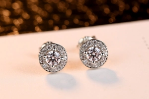 Macro shot of silver halo stud earrings with a large center zircon and pave setting
