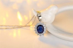 Macro shot of sunflower blue gemstone pendant necklace with white crystals on a silver chain