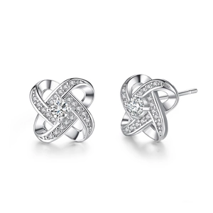 Detailed macro view of silver windmill stud earrings with sparkling cubic zirconia stones
