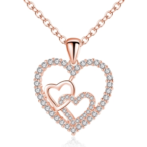 Macro detail of rose gold interlocking heart necklace pendant with shiny zircon stones