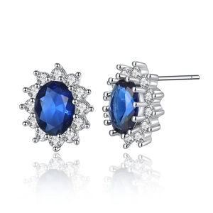 Elegant sunflower stud earrings with deep blue oval gemstone and white zircon halo on white background