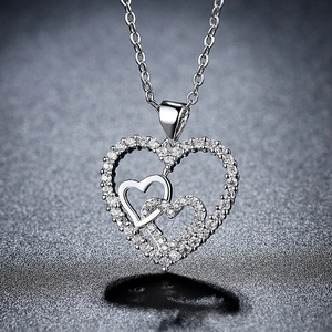 Intertwined triple heart pendant necklace with shimmering zircon stones on silver chain