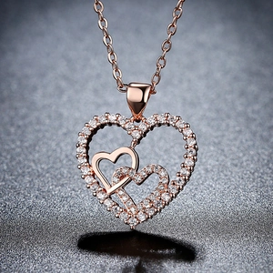 Elegant rose gold double heart pendant necklace featuring shimmering pave-set zircon stones
