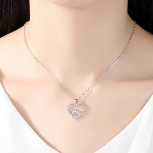 Elegant silver heart necklace with zircon pave frame worn on model for stylish look