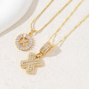 Golden iced-out cross pendant necklace with sparkling cubic zirconia on box chain