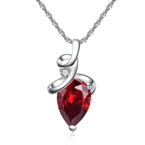 Macro detail of elegant pear-cut red gemstone pendant with twisted silver metal chain