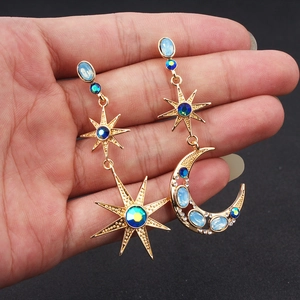 Bohemian asymmetric gold earrings with moon and star shapes with blue crystals