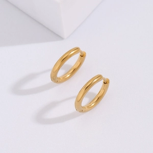 Minimalist gold-plated stainless steel hoop earrings with a polished mirror finish on white