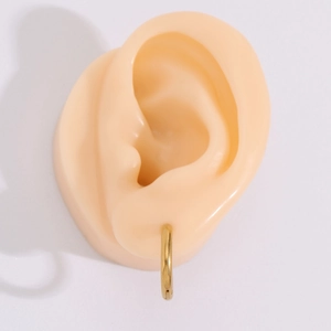 Minimalist gold hoop earrings for women crafted in polished stainless steel for a sleek look