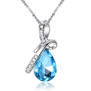 Macro detail of silver drop necklace with blue gemstone and sparkling zircon crystals