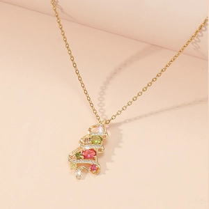 Detail of a Christmas tree pendant necklace with colorful zircon gemstones and gold chain