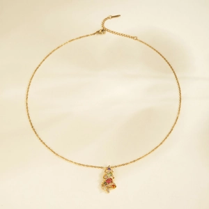 Golden Christmas tree necklace with colorful zircon stones on elegant satin background