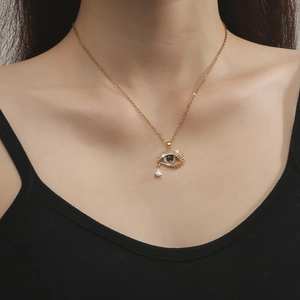 Collier mauvais œil doré avec zircons blancs et pierre noire sur un mannequin