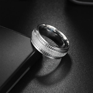 Men's wide stainless steel wedding ring with silver sandblast finish and grooved edges