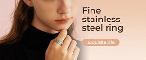 Close-up of stainless steel ring with Just Breathe engraving on a hand