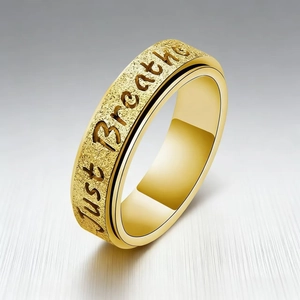 Golden titanium steel spinner ring for women engraved with Just Breathe quote