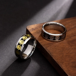 Polished punk skull rings in silver and gold tones on a professional wood display