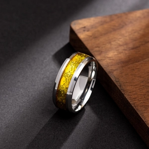 Detail of a silver steel ring with gold skull pattern band and polished metallic edges