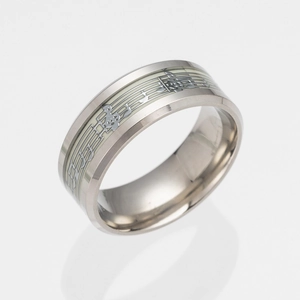 Detailed macro view of silver music note ring with glowing luminous staff pattern