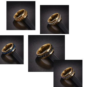 Detail shot of five rotating chain rings in gold finish with various color inlays