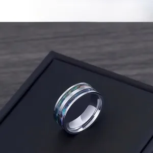 Macro shot of titanium steel ring with iridescent shell inlay and smooth inner arc design