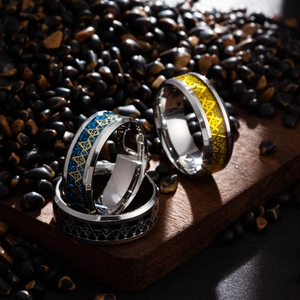 Macro shot of three Freemason rings in blue, gold and black enamel on polished steel