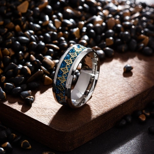 Detail of masonic ring with blue glitter inlay and gold geometric patterns on wood