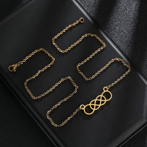 Polished gold interlocking circles necklace with infinity pendant on black display box