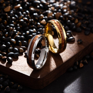 Detailed macro view of gold and silver titanium steel rings with natural wood inlay