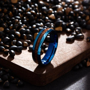 Detailed macro view of men's blue titanium steel ring with natural wood inlay texture