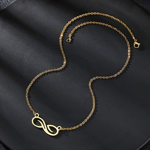 Elegant gold hollow infinity pendant necklace on matte black jewelry tray display