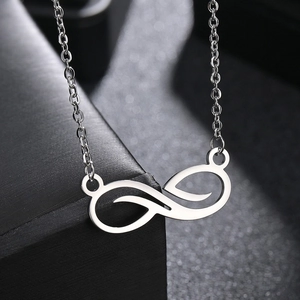 Women's infinity pendant necklace in silver stainless steel on a black jewelry gift box