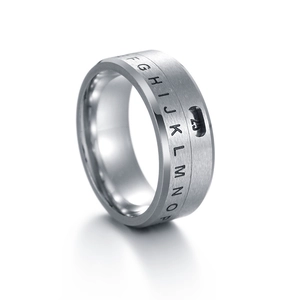 Close-up of brushed titanium steel spinner ring with engraved letters and number 25