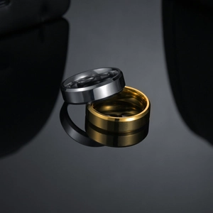 Close-up of 6mm silver and gold stainless steel rings with beveled edges and mirror finish
