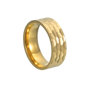 Detail view of 8mm wide golden hammered texture titanium steel ring with polished inner surface