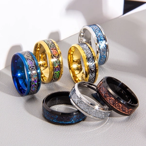 Detail showing various dragon-patterned celtic rings in silver, gold, and black finishes