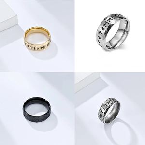 Detail view of four Nordic Viking rune rings in gold silver black and antique finishes
