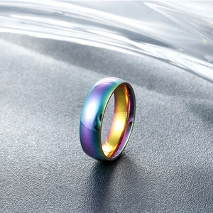 Macro detail of iridescent rainbow titanium steel ring with polished finish