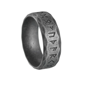 Macro shot of Nordic Viking Rune ring featuring hammered texture and vintage steel finish