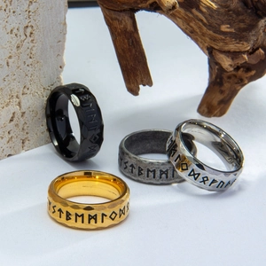 Macro detail showing Viking Rune engravings and hammered texture on Nordic steel rings