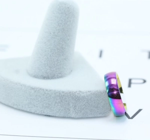 Macro shot of iridescent rainbow titanium steel ring showing multi-color gradient finish