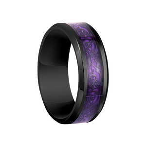 Detailed macro view of black stainless steel ring with purple celtic dragon inlay motif