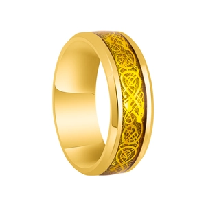 Detail of golden ring featuring Celtic dragon pattern inlay and polished finish