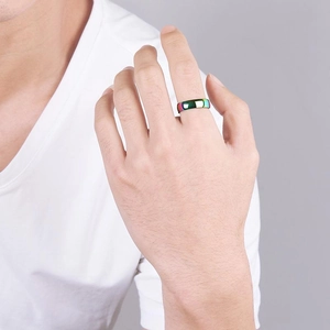 Minimalist rainbow titanium steel ring for men worn on a hand against a grey background