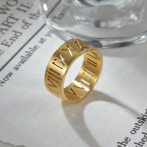 Primer plano del anillo de acero dorado de 8mm con diseño calado de números romanos